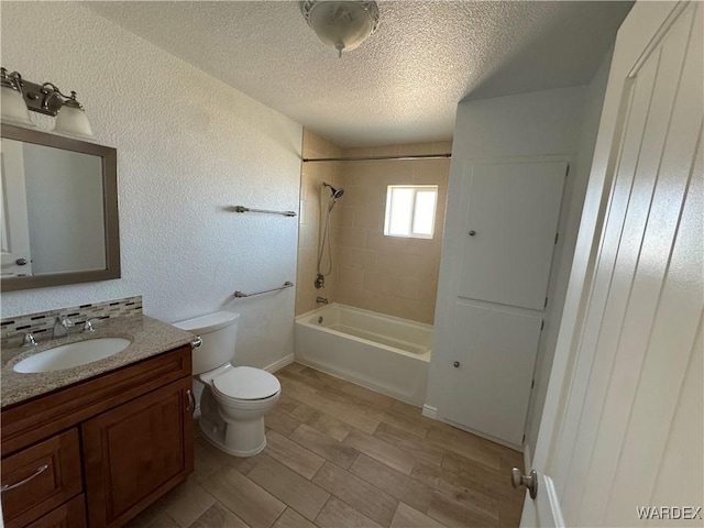 full bathroom featuring a textured ceiling, a textured wall, toilet, wood finished floors, and bathing tub / shower combination