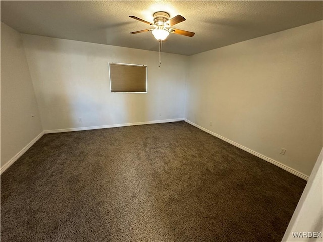 unfurnished room featuring a ceiling fan, dark colored carpet, a textured ceiling, and baseboards