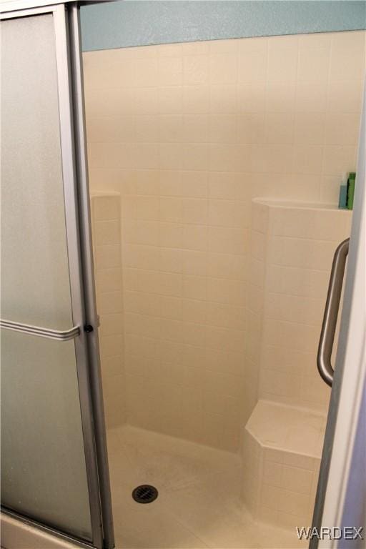 bathroom with a tile shower