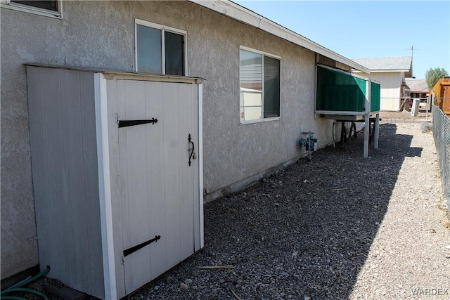 view of property exterior with a fenced backyard and stucco siding