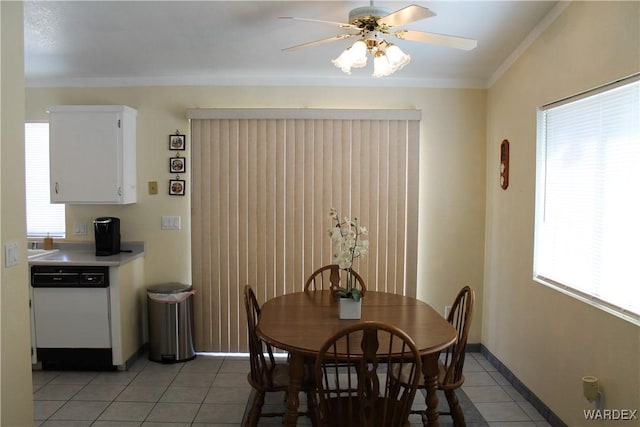 dining room with ornamental molding, a healthy amount of sunlight, ceiling fan, and light tile patterned floors