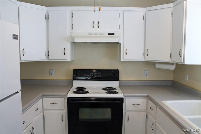 kitchen with under cabinet range hood, white cabinets, electric stove, light countertops, and freestanding refrigerator