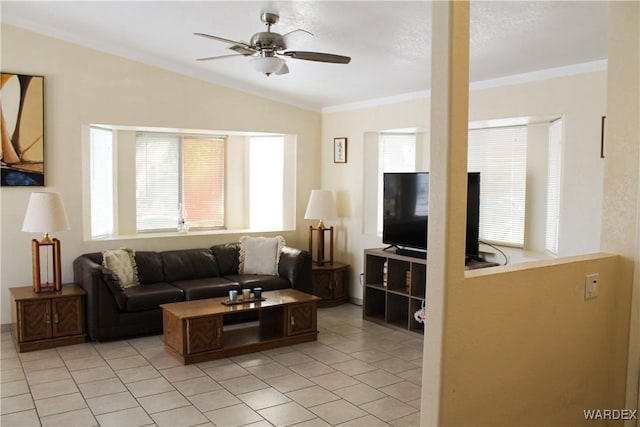 living room featuring ornamental molding, light tile patterned floors, vaulted ceiling, and a ceiling fan