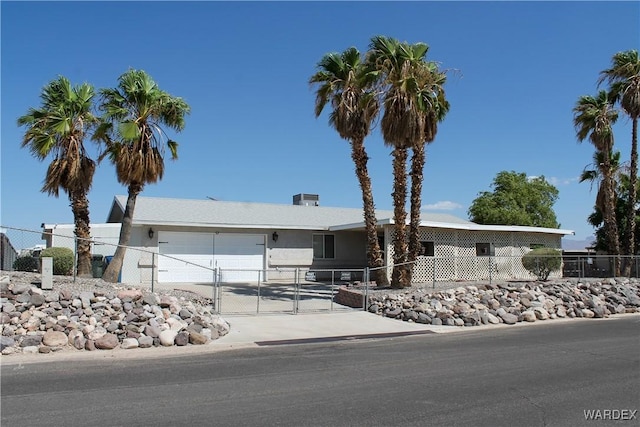 manufactured / mobile home featuring driveway, an attached garage, and fence