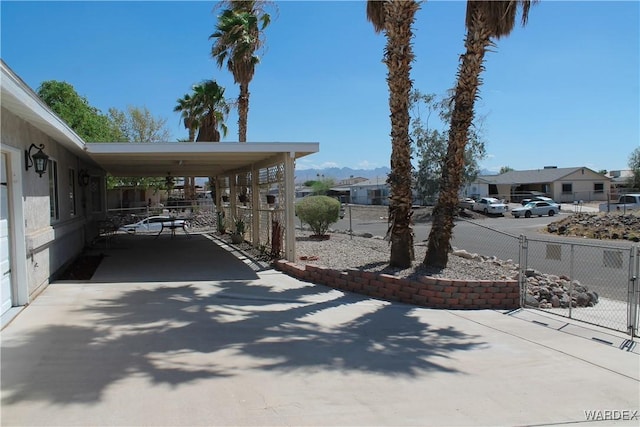 exterior space featuring a residential view and fence