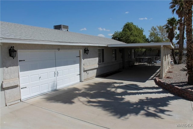 ranch-style house featuring concrete driveway, a shingled roof, and stucco siding