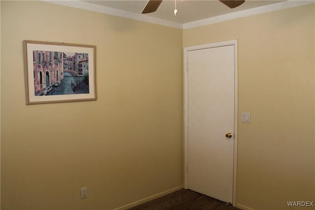 carpeted empty room featuring ceiling fan and baseboards