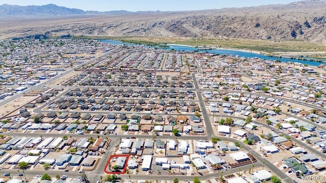 drone / aerial view with a residential view and a water and mountain view