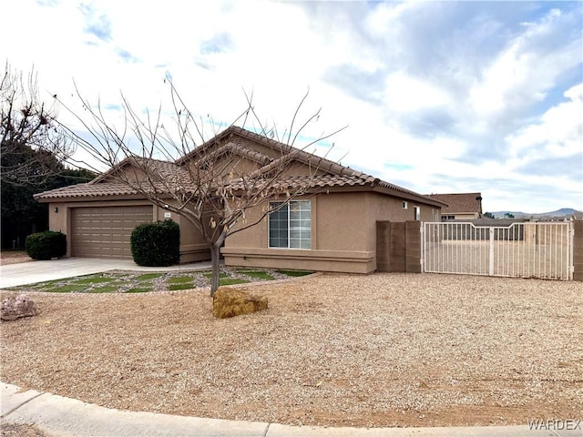 view of property exterior with driveway, a tiled roof, fence, and stucco siding