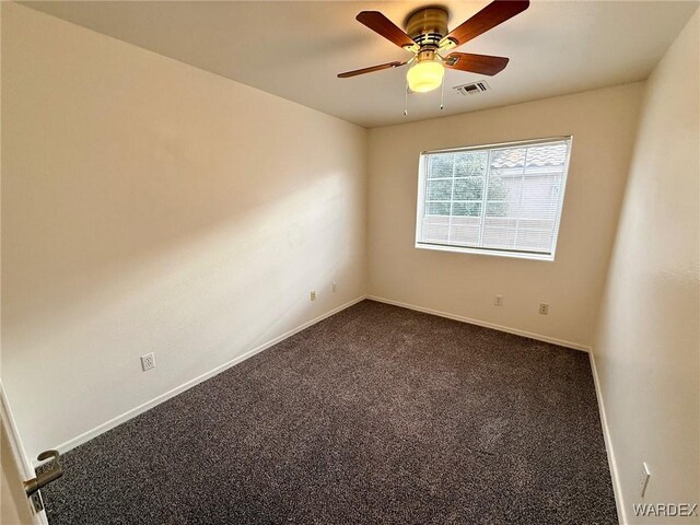 carpeted empty room featuring a ceiling fan, visible vents, and baseboards