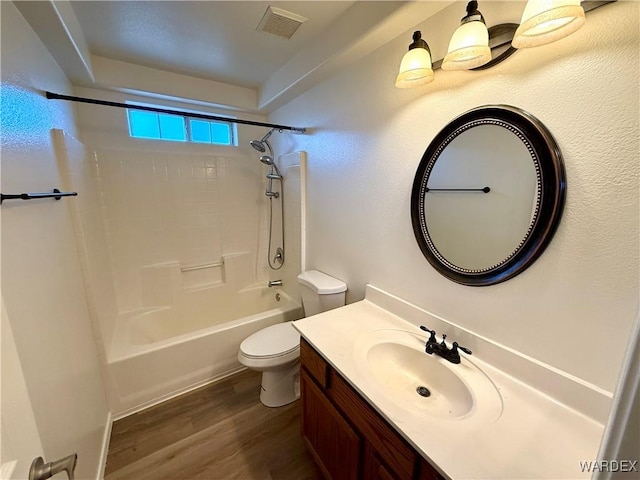 bathroom featuring shower / bathtub combination, toilet, wood finished floors, visible vents, and vanity