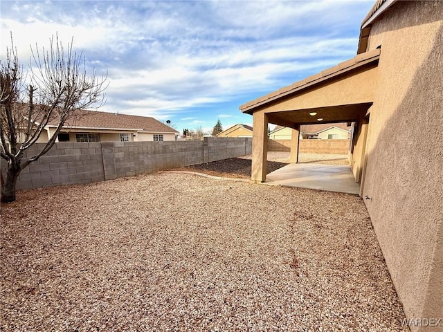 view of yard with a fenced backyard and a patio