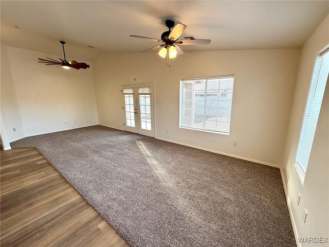 carpeted spare room with lofted ceiling, ceiling fan, french doors, and baseboards