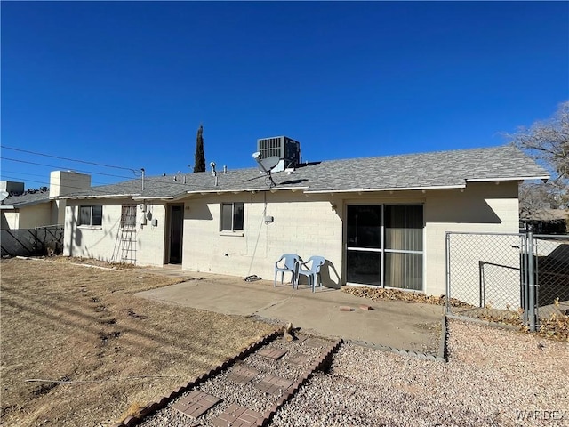 rear view of house featuring a patio area, fence, and cooling unit