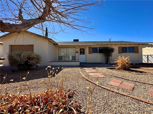 single story home with a patio area and an attached garage