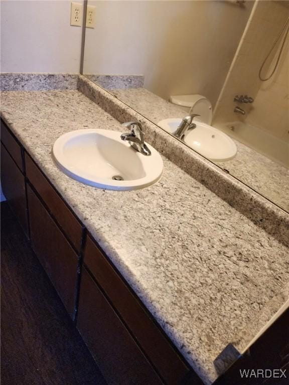 bathroom featuring shower / bathing tub combination, vanity, and toilet