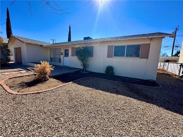 single story home with a garage and fence