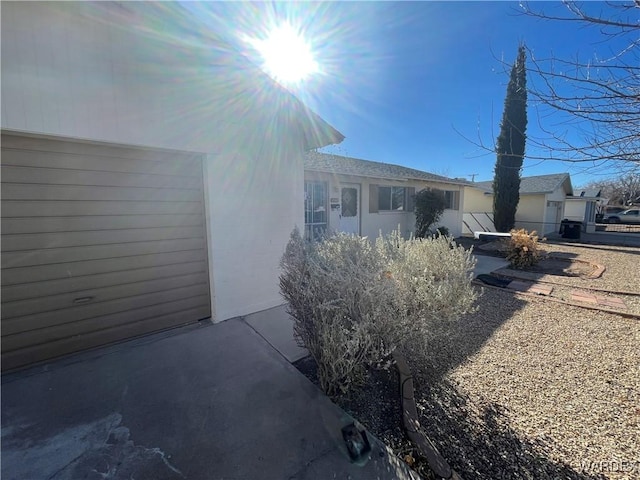 view of side of property featuring a patio and stucco siding