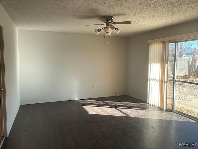 spare room featuring a textured ceiling, ceiling fan, and wood finished floors