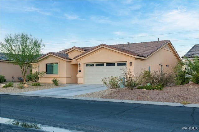 single story home with a garage, driveway, a tiled roof, and stucco siding