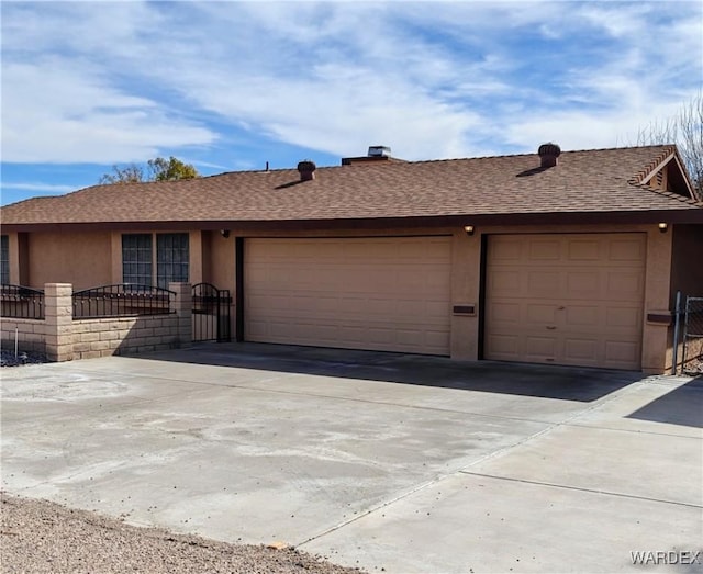 ranch-style house featuring an attached garage, fence, concrete driveway, roof with shingles, and stucco siding