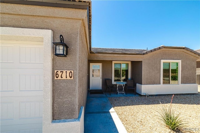 property entrance with stucco siding