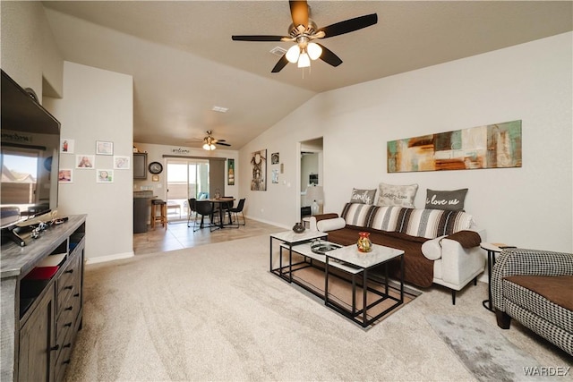 living room with baseboards, ceiling fan, lofted ceiling, and light carpet