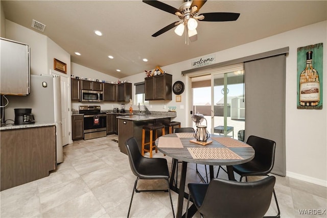 dining room featuring a ceiling fan, baseboards, recessed lighting, vaulted ceiling, and visible vents