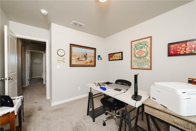 office featuring visible vents, baseboards, and light carpet