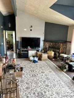 living room with vaulted ceiling and a fireplace