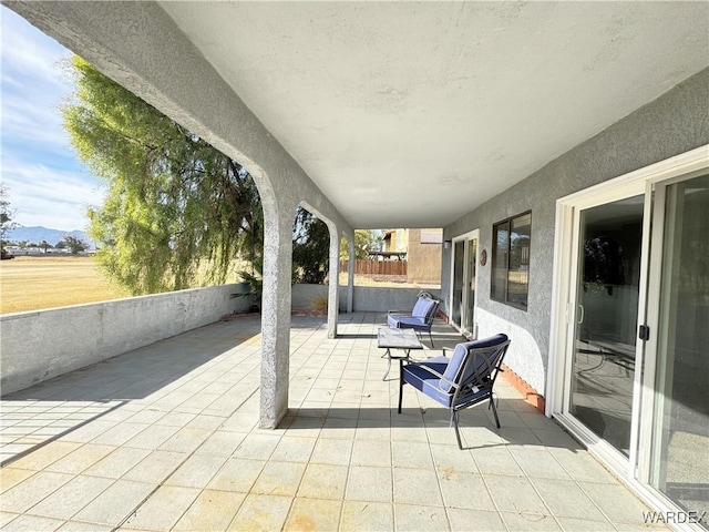 view of patio / terrace with a mountain view and fence