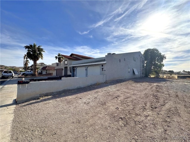 view of front of home with an attached garage and stucco siding