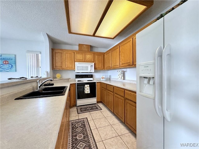 kitchen featuring light tile patterned floors, white appliances, a sink, light countertops, and brown cabinetry