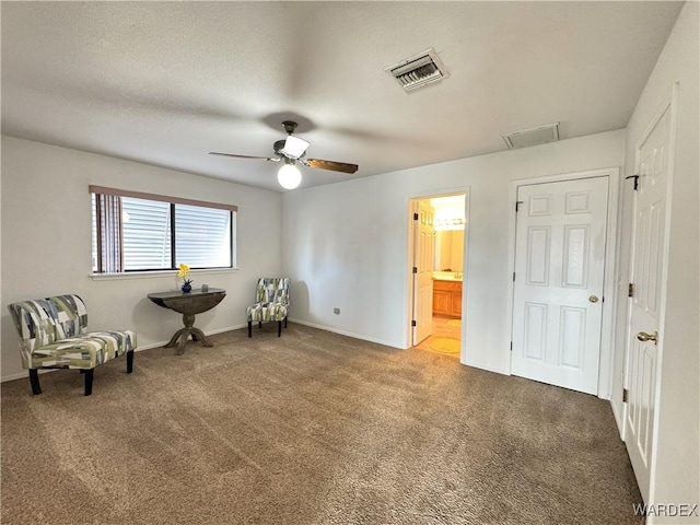 unfurnished room featuring carpet floors, a ceiling fan, visible vents, and baseboards