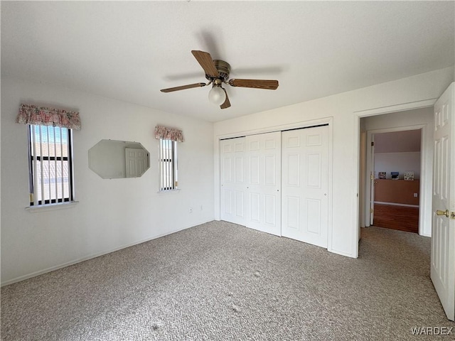 unfurnished bedroom featuring carpet floors, a ceiling fan, and a closet