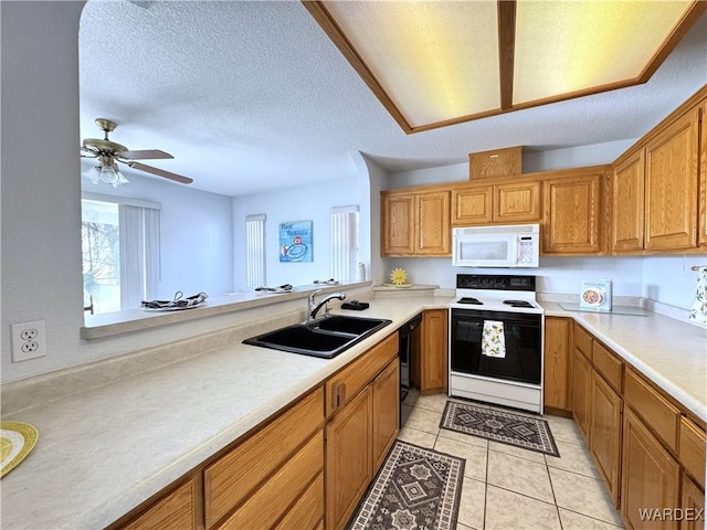 kitchen featuring white microwave, light countertops, and range with electric stovetop