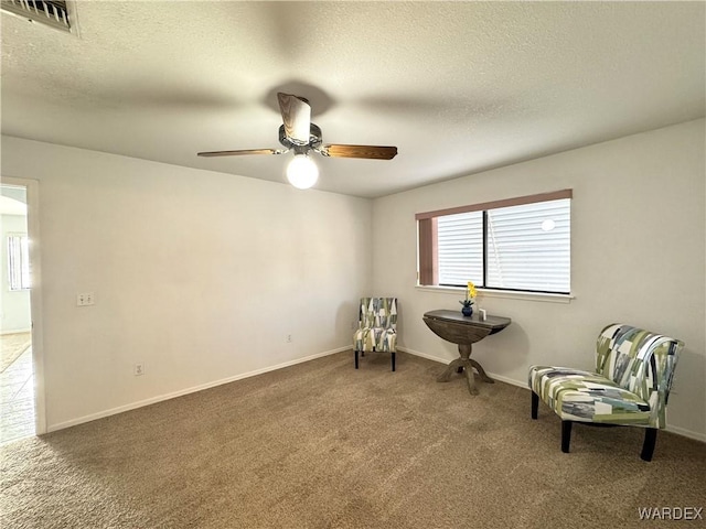 unfurnished room featuring carpet floors, visible vents, a textured ceiling, and baseboards