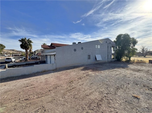 view of property exterior featuring an attached garage and stucco siding