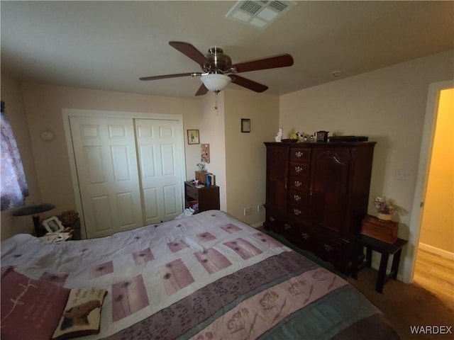 bedroom featuring a closet, visible vents, and ceiling fan