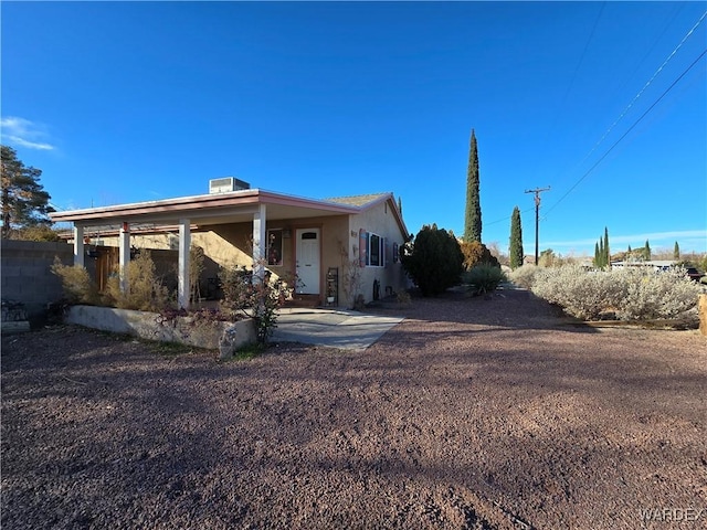 exterior space featuring driveway and stucco siding