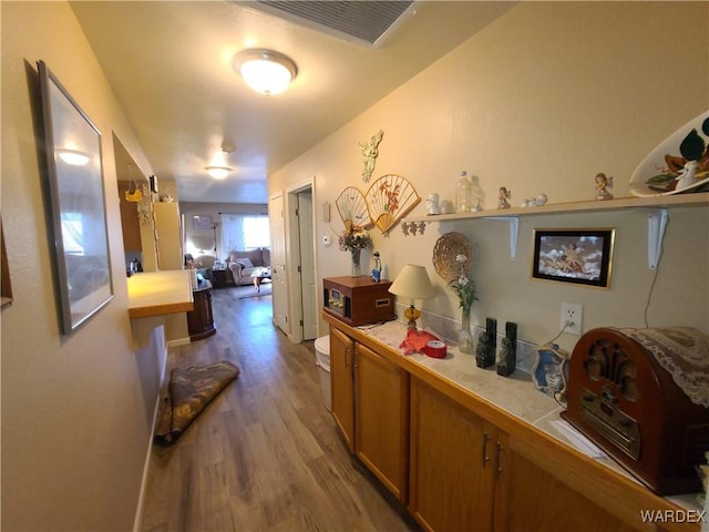 hall with light wood finished floors and visible vents