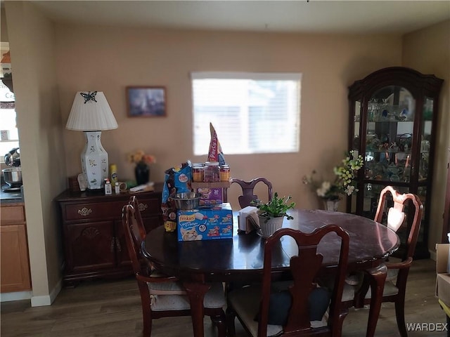 dining area featuring dark wood-type flooring