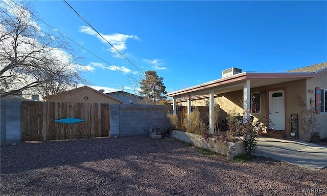 view of property exterior featuring fence and stucco siding