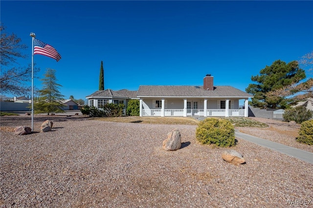 view of front of home with a porch and a chimney