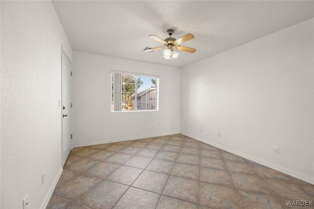 unfurnished room with a ceiling fan and baseboards