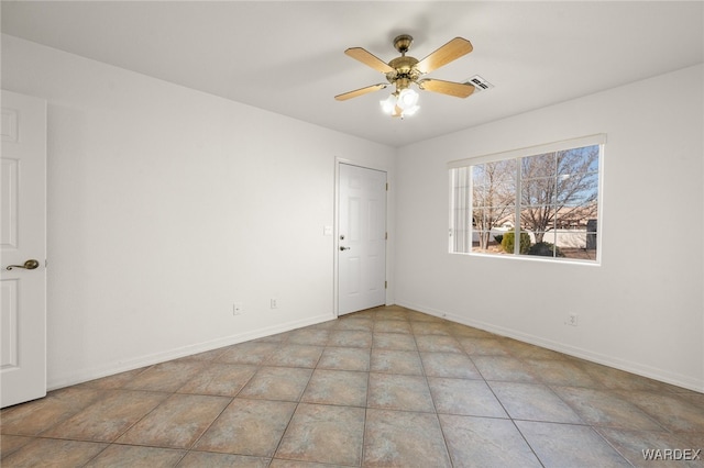 unfurnished room with a ceiling fan, visible vents, baseboards, and light tile patterned floors