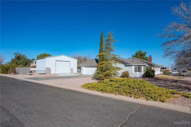 view of front of property featuring a garage and a chimney