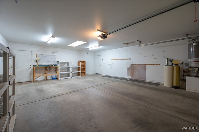 garage featuring gas water heater and a garage door opener