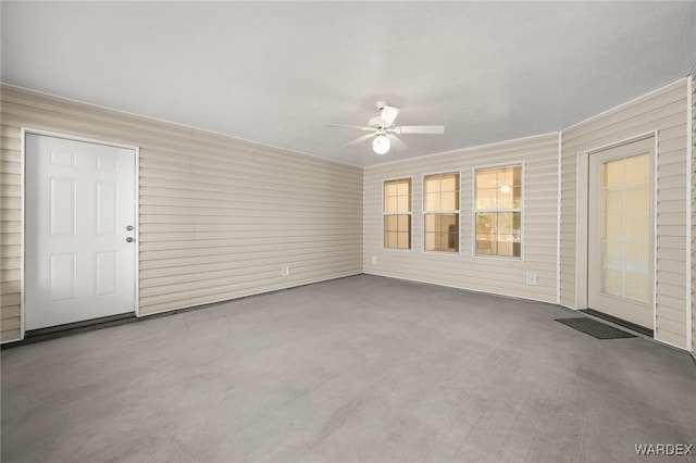 spare room featuring concrete floors and a ceiling fan