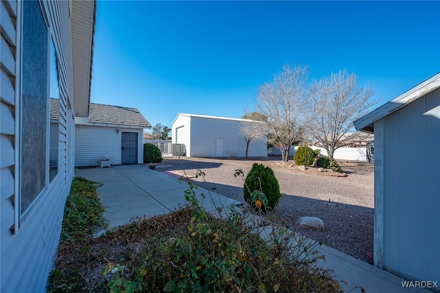 view of yard featuring an outbuilding and a patio area